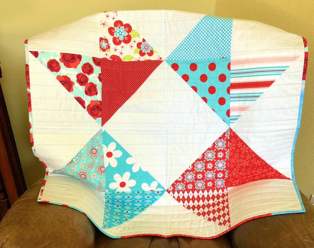 layer cake baby quilt in aqua red